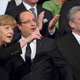 Merkel points before the concert starts, too, and has Hollande impressed.